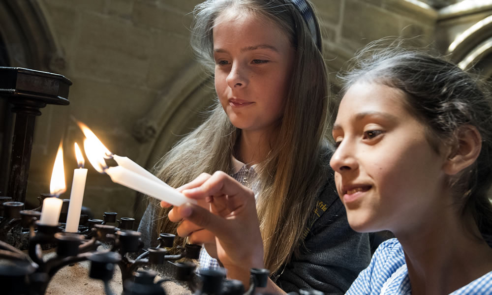 Girls lighting candles in the Minster